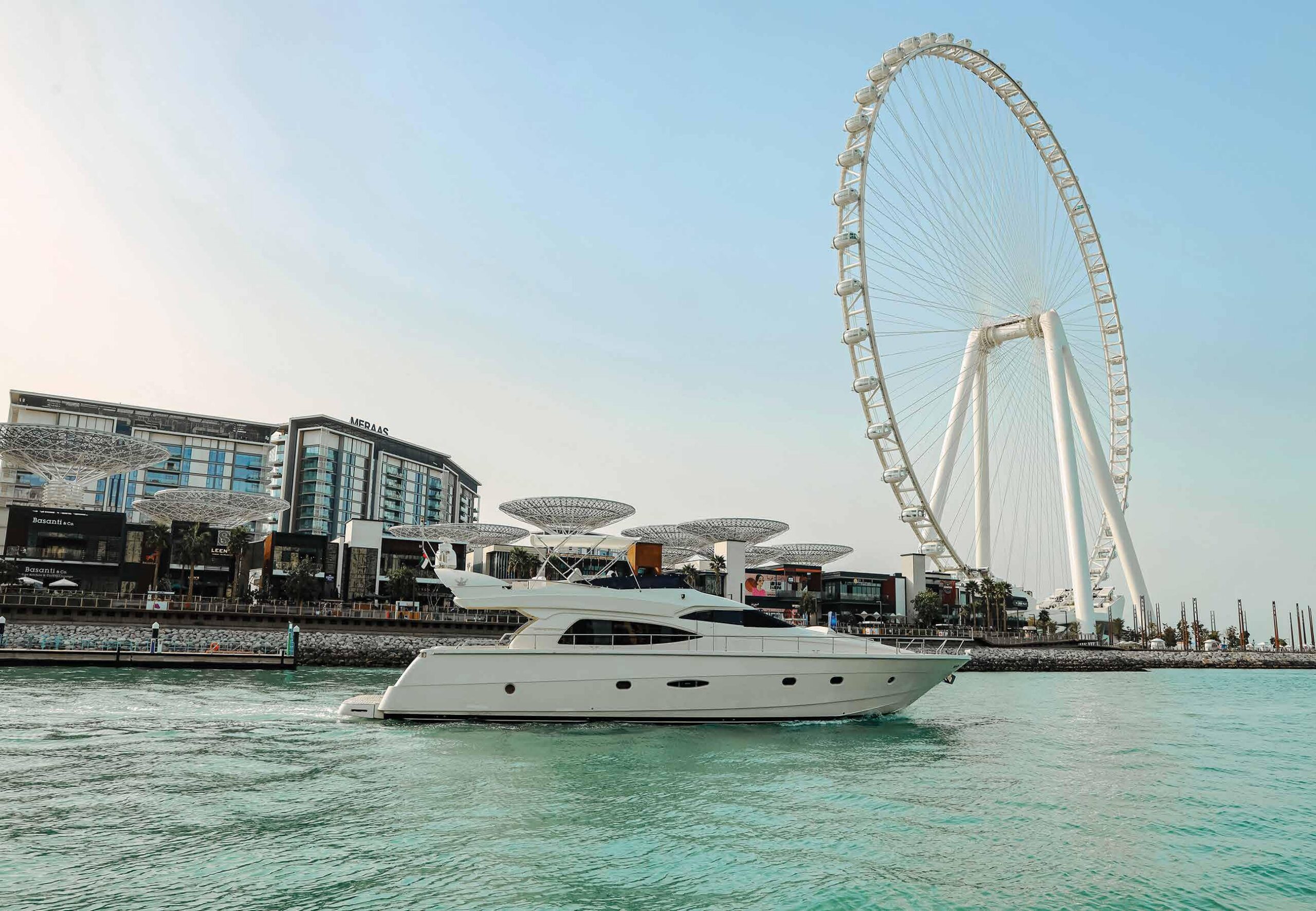 66 ft yacht cruising near Dubai Marina with a Ferris wheel view